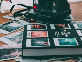 photo of polaroid camera near book
