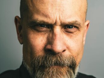 bald man with a serious facial expression